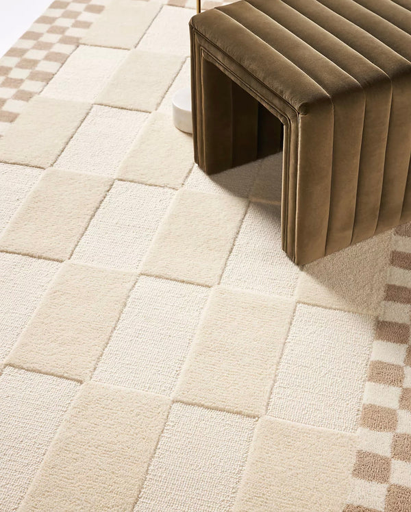 Beige textured rug with a brown bench on top